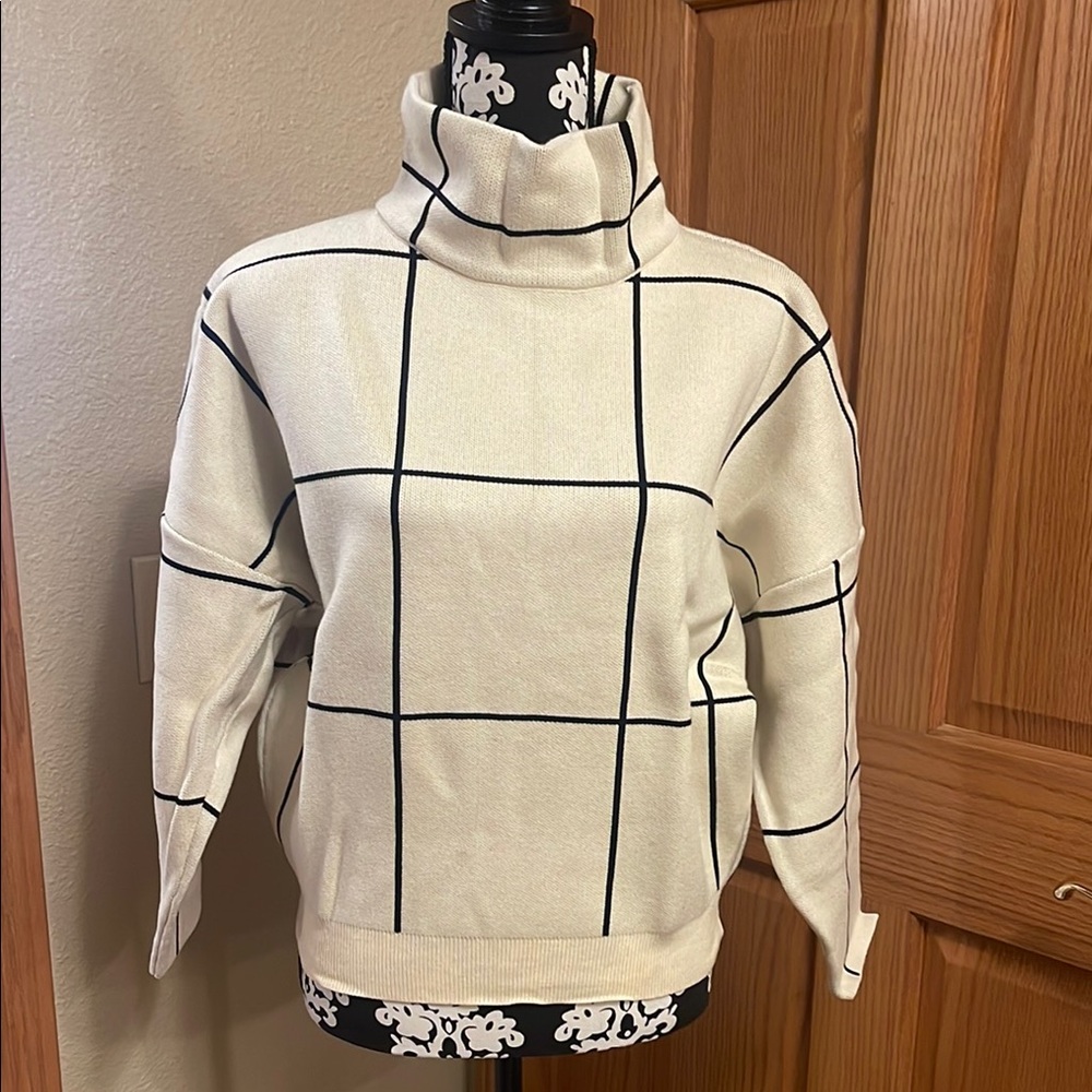 Cream Turtleneck Sweater with Black Grid Pattern